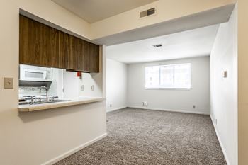 A room with a window and a microwave.